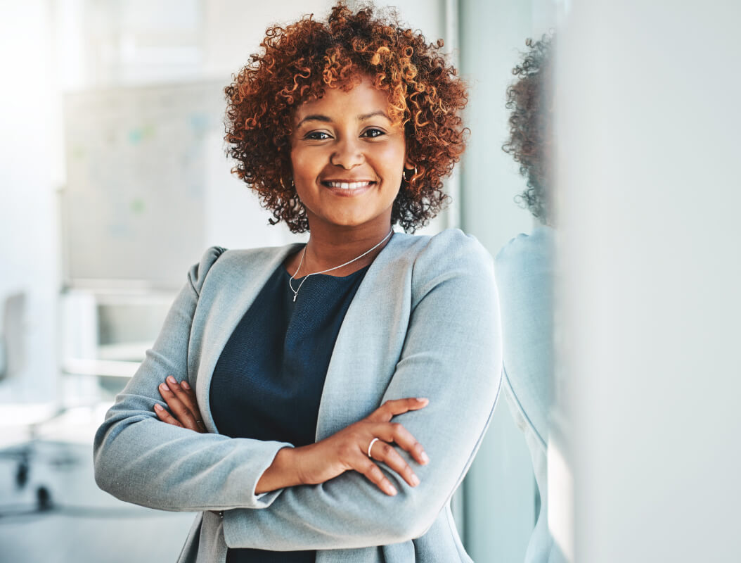 Jeune femme professionnelle, confiante, souriant et fixant la caméra du regard