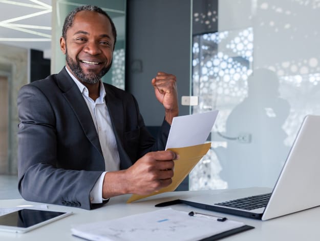 Un homme d'affaires confiant, assis dans son bureau avec une lettre, symbolisant les services de lettre de crédit offerts par Capital Bank